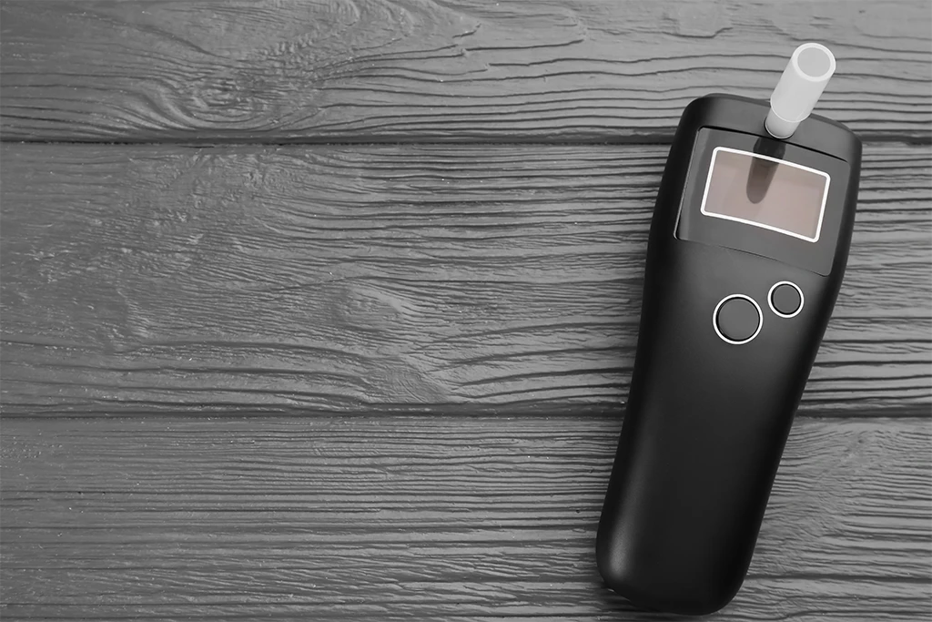 modern-breathalyzer-on-grey-wooden-background-top